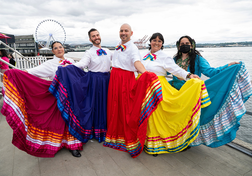 People posing in colorful clothing.