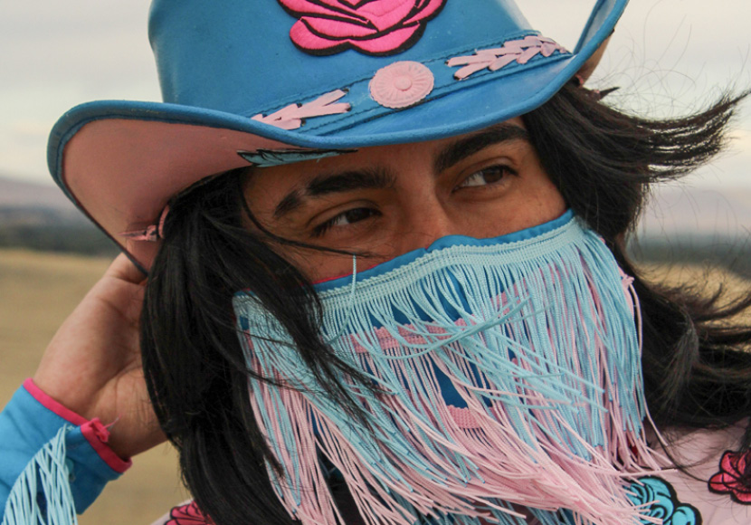 Person in colorful hat and mask